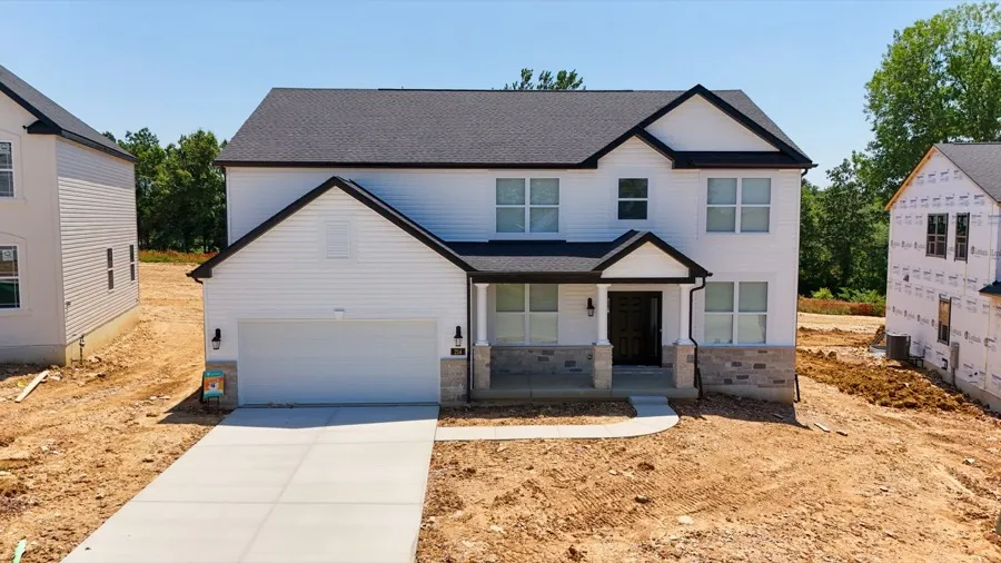 New construction home with stone accents and a two-car garage, used as a floor plan card photo